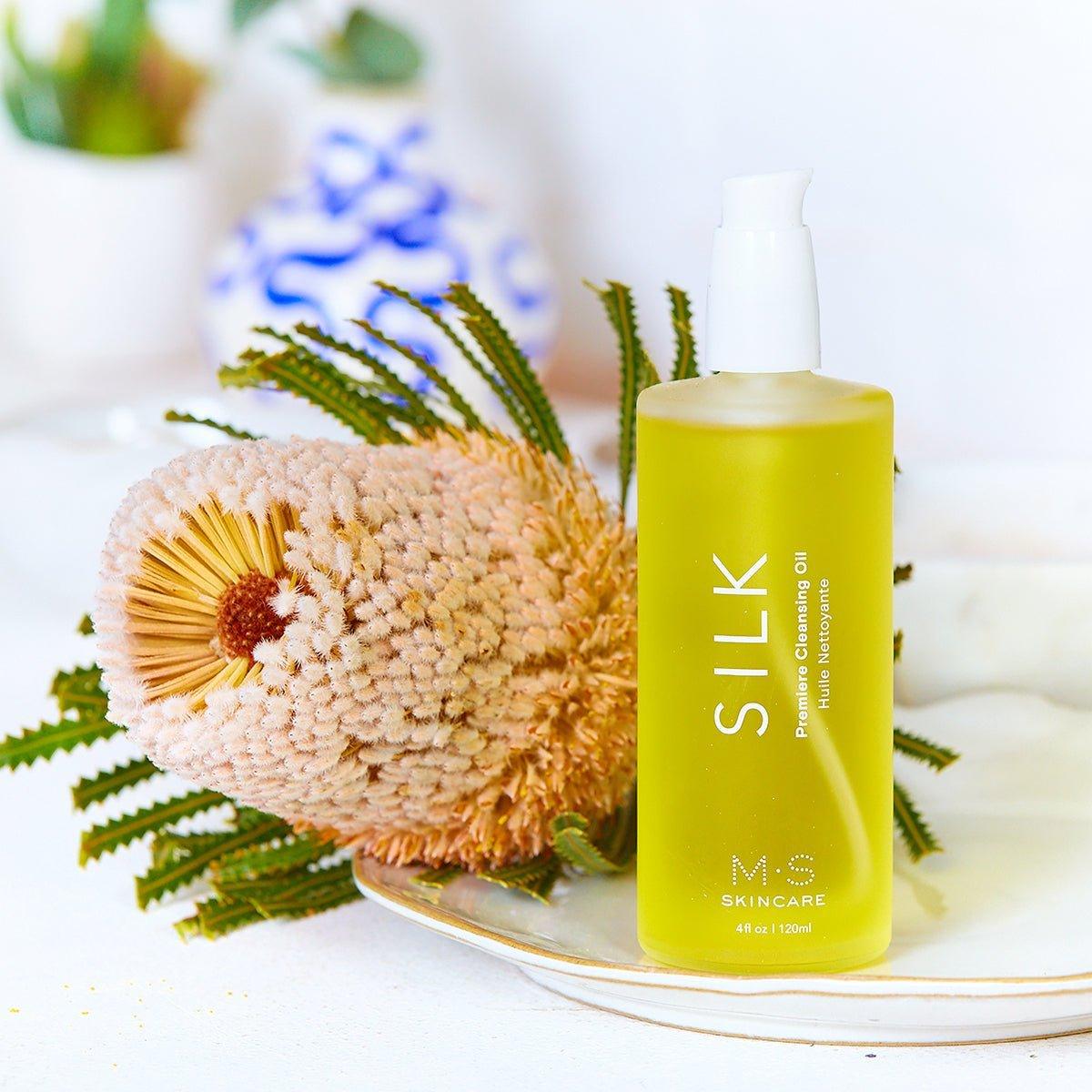 M.S Skincare SILK Premier Cleansing Oil-golden Ayurvedic oil in a frosted bottle with white printing and cap with big flower.